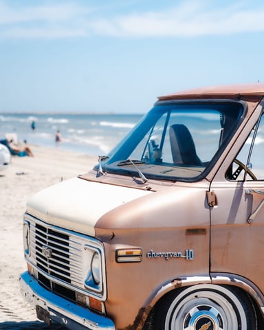 Vintage van parked on the Gulf beach on a clear sunny day
