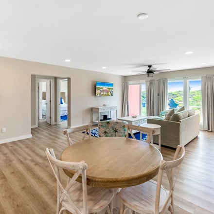 Casa Unit 102 — dining table and living room with Gulf greenery views