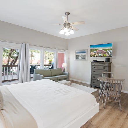 Casa Unit 109 — bedroom with balcony and palm tree views